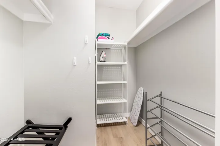 "Generous walk-in closet with shelving, luggage rack, iron, and ironing board — packed for long stays."