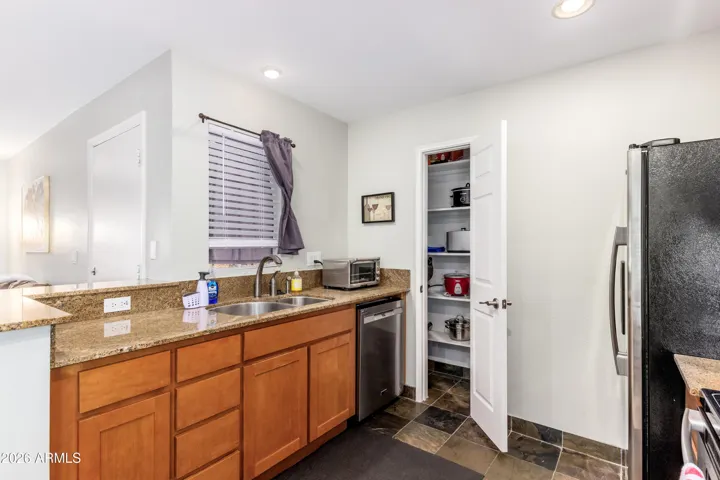 "Full-size dishwasher, deep sink, and an open pantry loaded with cookware — everything a traveling nurse or relocating professional needs to cook like home."