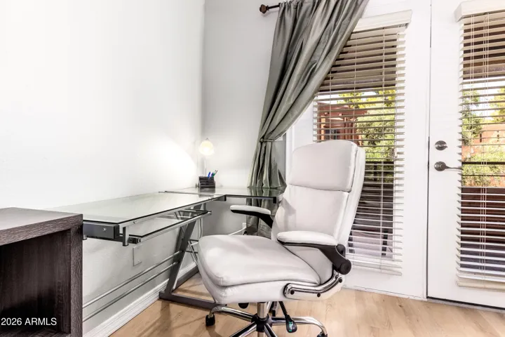 "Corner office, seriously — glass desk, ergonomic executive chair, and a green view. Productivity meets comfort."