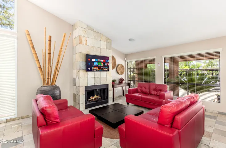 "Unwind beyond your unit — the stunning community clubhouse features a stone fireplace, smart TV, and bold red leather seating. A resort-level bonus for long-stay guests."