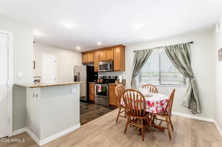 "Cook, eat, unwind — full stainless kitchen and a cozy 4-seat dining nook, perfect for snowbirds and long-stay guests settling into a routine."