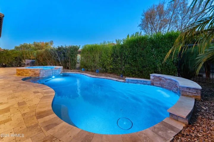 Gorgeous sheer descent water feature flowing from spa into pool