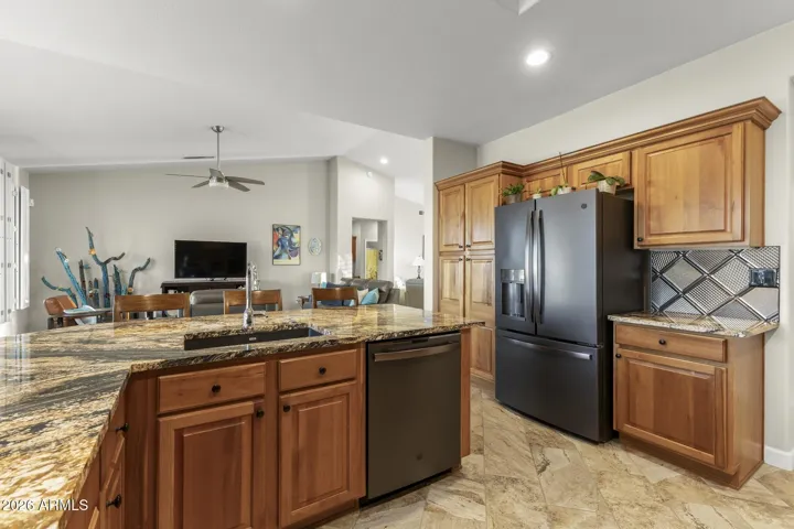 Here, you see the 36" counter depth, 3 door refrigerator, new dishwasher in black stainless steel with a matte finish, and a pantry cabinet.