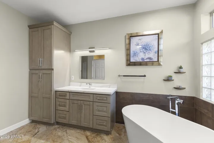 A large floor to ceiling cabinet has plenty of room for towels and other linens.