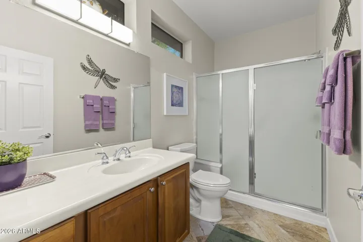 The hall bath has a walk-in shower, large vanity, quartz top, and new toilet.