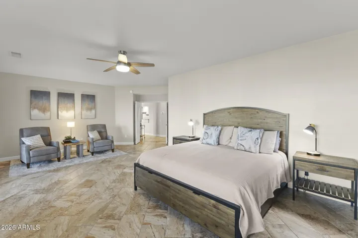 The resort style primary suite is huge. There is a beautiful sitting area, plenty of space for a king sized bed and more - but the treat is looking out of the huge windows and slider at the golf course! Plantation shutters provide privacy and light control.