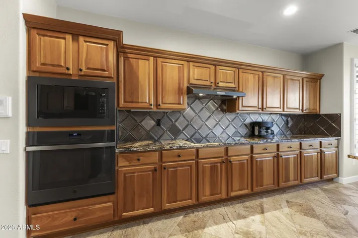 If you are a cook, you will love this - an induction cooktop, a convection oven and microwave with a stylish tile backsplash and lots of prep space.