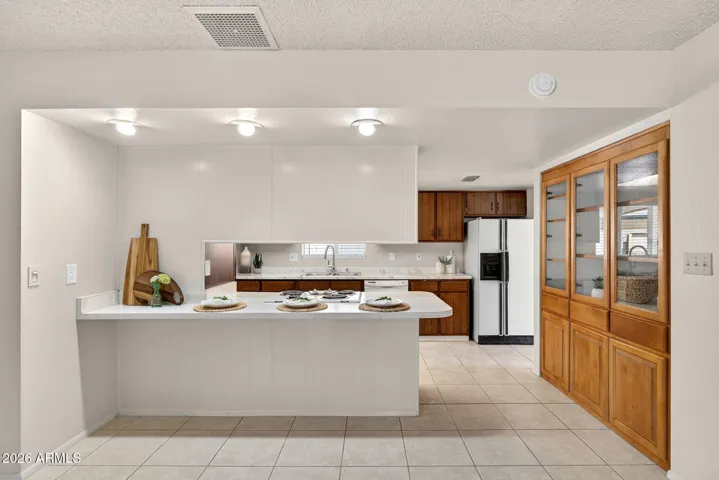 Counter space for barstools and a custom built in china cabinet.