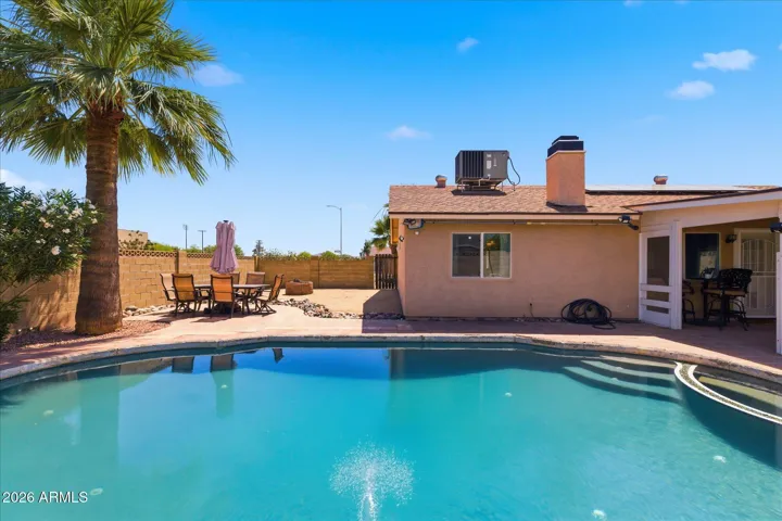 Cool off on those sizzling AZ days in this pebbletec pool with cool separate seating area. Set off to the side, there is still ample space for a playground, dog run or anything else!