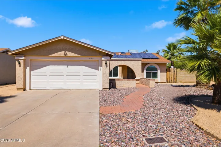 Welcoming front entry features pavered walkway and covered patio area perfect for enjoying your coffee!