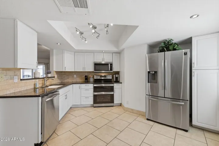 With a cute window seat looking onto the front patio, this space is great for multiple cooks or friends to gather!