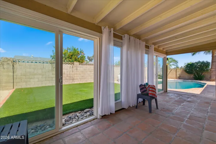 Great for entertaining and storage, this covered patio turned AZ room features full glass floor to ceiling on 3 sides with flexible options to re-design the space to your needs!
