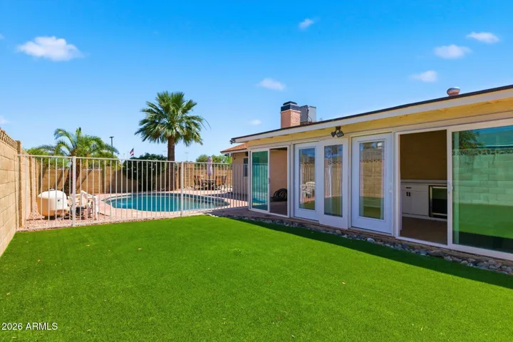 Complete with an AZ room, great for storage and covered entertaining in the yard, this oasis features a synthetic grass play area, firepit area, and an RV gate with room to store your toys!