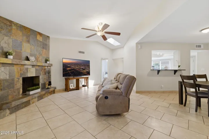 Natural light pours in though the sunlight and windows and the vaulted ceilings create an elegant, spacious feeling. Tiled throughout for low allergens and ease of care. Complete with wood burning fireplace for ambiance!