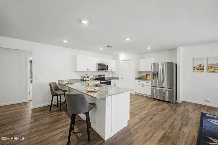 Kitchen includes newer Frig, Garbage Disposal, Microwave, Dishwasher, Range, and plenty of cabinets!