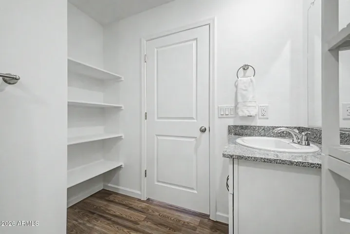 Bathroom has linen shelving!