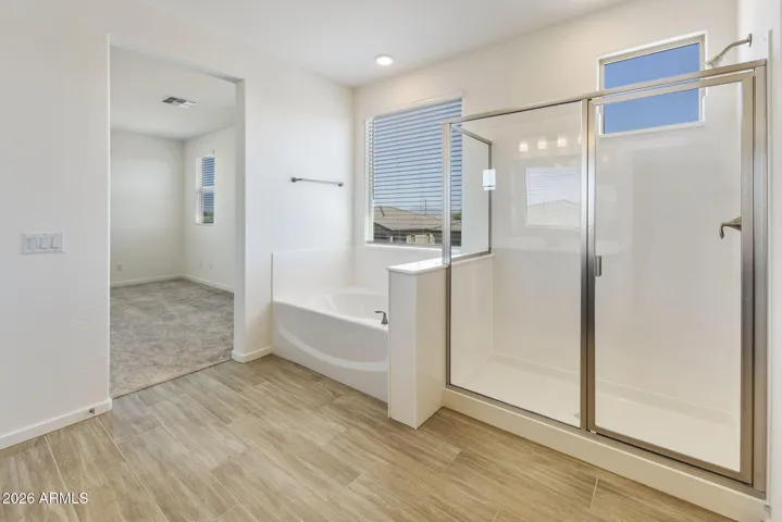 OWNER'S BATH HAS DUAL VANITIES, HIS AND HER CLOSETS, SEPARATE TUB AND SHOWER AND LOTS OF STORAGE!