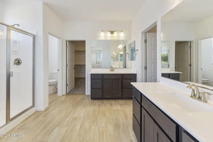 OWNER'S BATH HAS DUAL VANITIES, HIS AND HER CLOSETS, SEPARATE TUB AND SHOWER AND LOTS OF STORAGE!