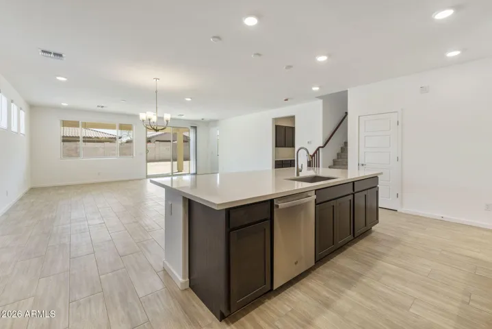GOURMET KITCHEN WITH BUILT-IN APPLIANCES, STAGGERED CABINETS, QUARTZ COUNTERS AND A DESIGNER BACKSPLASH.