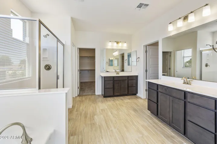 OWNER'S BATH HAS DUAL VANITIES, HIS AND HER CLOSETS, SEPARATE TUB AND SHOWER AND LOTS OF STORAGE!