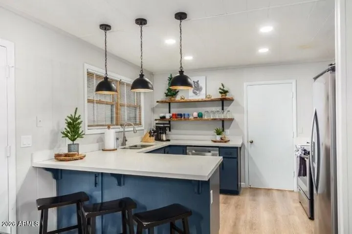 Full kitchen with counter seating.