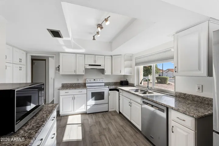 A larger kitchen with newer cabinets and appliances.