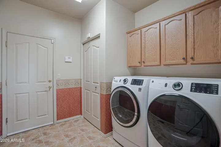 Laundry with broom closet and garage entry