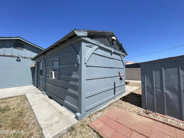 DETACHED OUTBUILDING ON SLAB FOUNDATION WITH ELECTRIC * WINDOW AC UNIT DOES NOT CONVEY