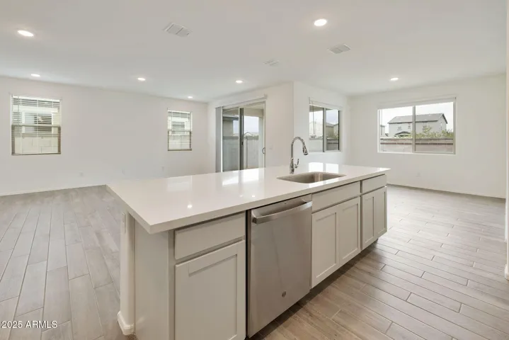 PAINTED CABINETS, QUARTZ COUNTERS, DESIGNER BACKSPLASH, STAINLESS STEEL APPLIANCES AND LARGE WALK IN PANTRY