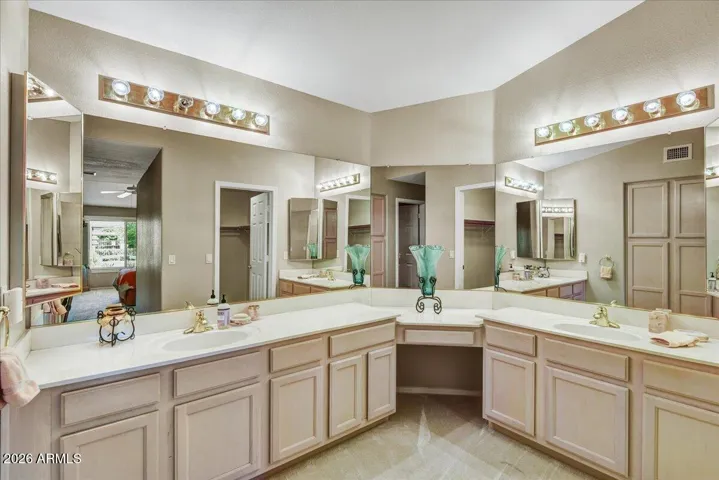 The ensuite primary bath features dual sinks and a clean, bright aesthetic for a spa-like feel.