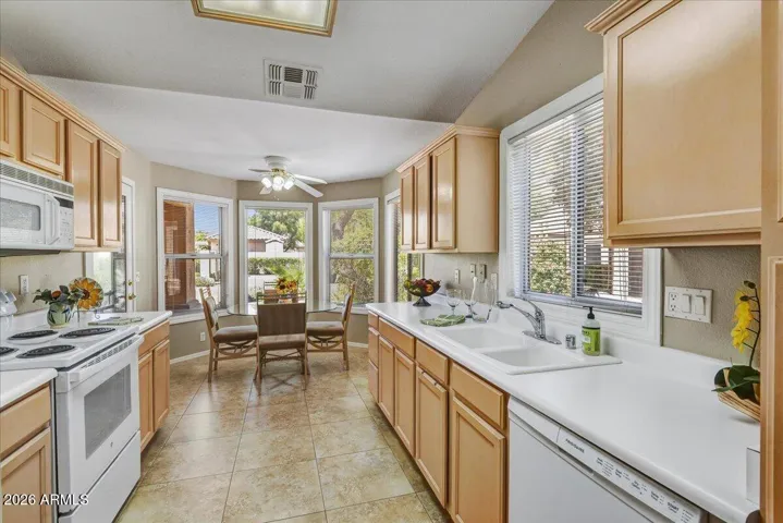 This chef-friendly kitchen features ample cabinetry, generous counter space, and a functional layout that overlooks the living areas.
