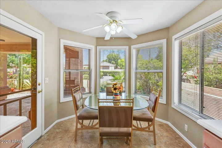 Enjoy your morning coffee in this sun-drenched breakfast nook, complete with large windows offering peaceful views.