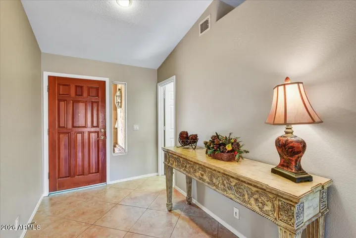 A bright and welcoming foyer greets you, setting the stage for the open and airy layout found throughout the home.