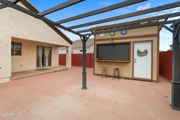 The backyard is set up for entertaining! The bar can be used as a bar or added storage.