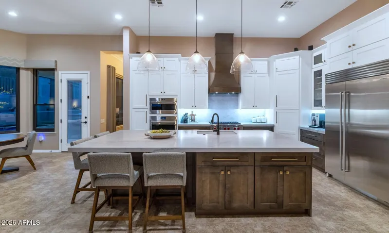 Completely remodeled gourmet kitchen w/sub zero fridge, WOLF gas cooktop, 10 ft island, expansive cabinetry w/all the bells & whistles, quartzite counters, floating shelves & other decorator touches.
