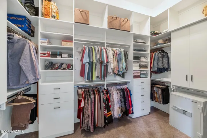 Large walk-in closet with custom drawers & shelves maximizing storage (floor safe does NOT convey at close of escrow)