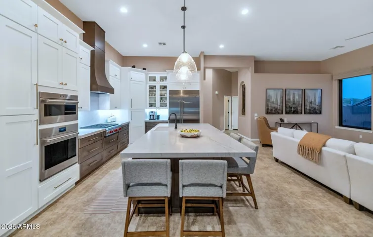 Expansive cabinetry with satin bronze accents, double-stacked kitchen uppers with 42" main cabinets & 16" top stacks, eye-catching white & wood cabinetry, recycling center, soft close features, obscure glass door accents, double built-in cutlery drawer & slotted storage for cooking sheets/cutting boards.