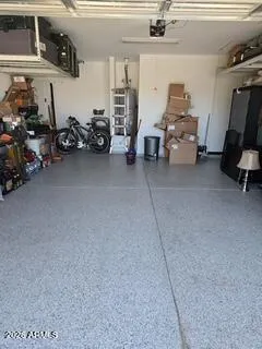 Garage has epoxy floors and hoverhead storage