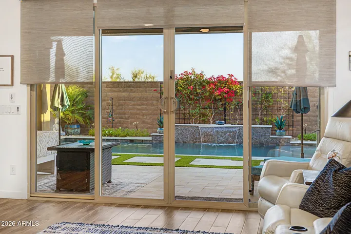 LR to back yard and pool. Shades over windows and slider are automatically operated.