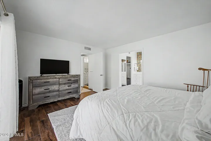 Filled with natural light, view to bathroom and closet.