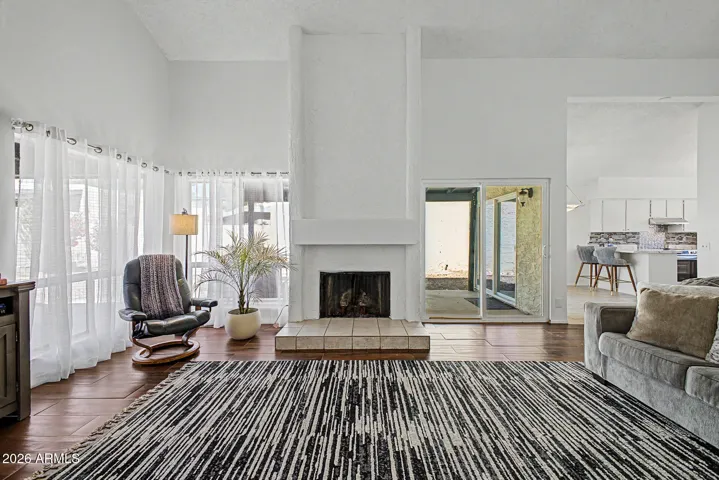 Wood burning fireplace, view of breakfast bar in kitchen.