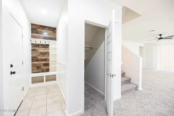 Garage door to left. Mud room, mouse hole, stairs, living room