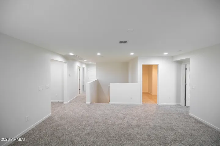 Hall bedrooms and bathroom to left, laundry room and master bed to right