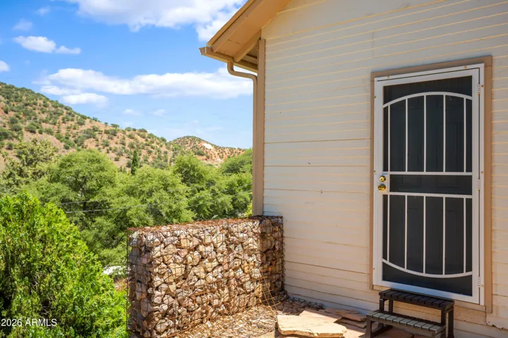 Private entrance and beginning of gabion wall, flagstone is laid and ready for you to make it your own!