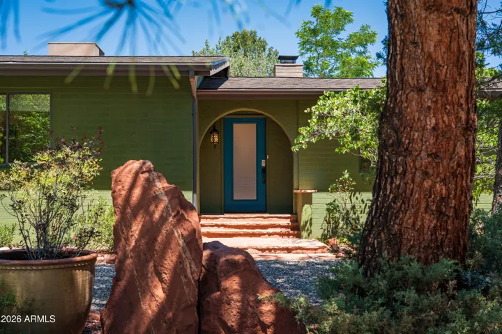 Inviting front exterior with mature landscaping and classic Sedona character have produced about 100k in gross rental revenue