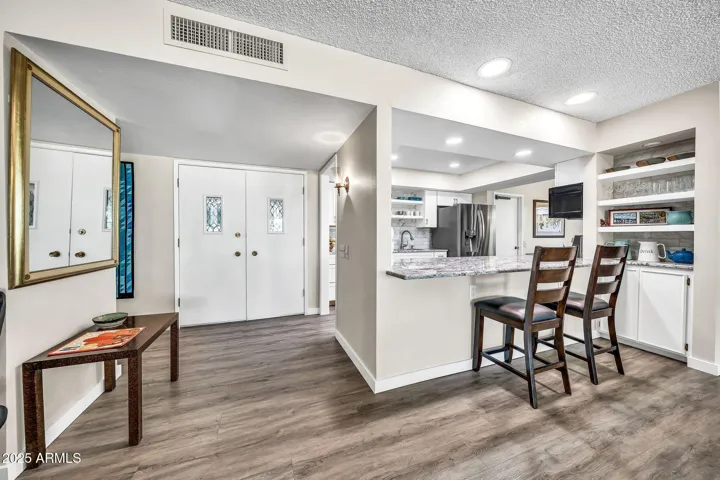 The kitchen, breakfast bar, and entrance