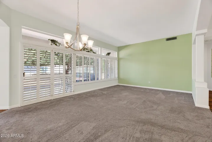 23 VIEW OF DINING ROOM WITH LIVING ROOM IN BACKGROUND.