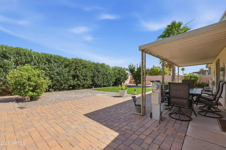 pavers, artificial grass and raised flower beds