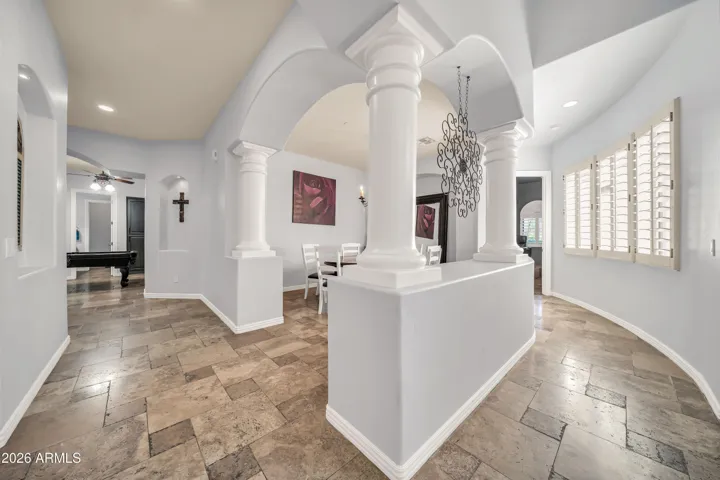 Hallway leading to theater room, dining room, bedrooms and flex space.