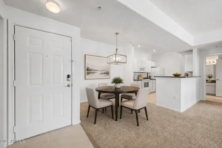 Modern light fixture over dining area (digitally staged)